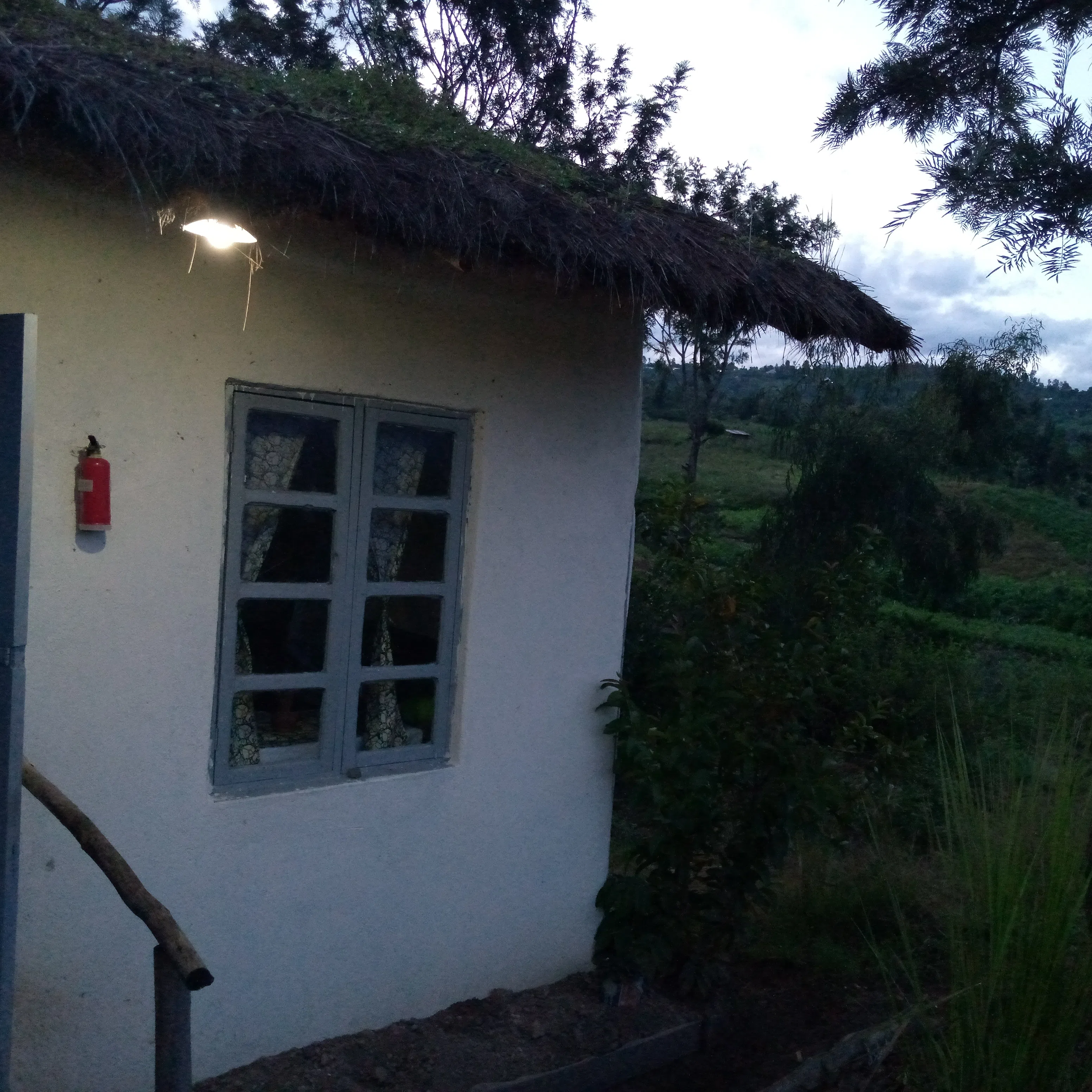 a cottage in the rwandan countryside at dusk